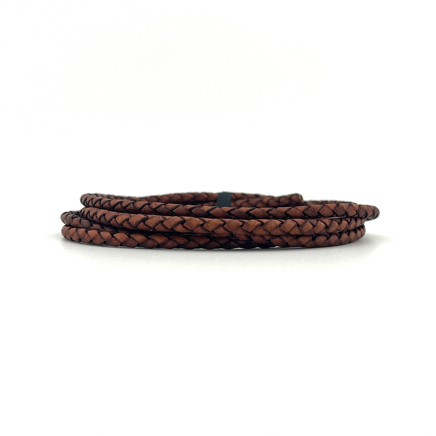 Brown braided leather cord on a white background