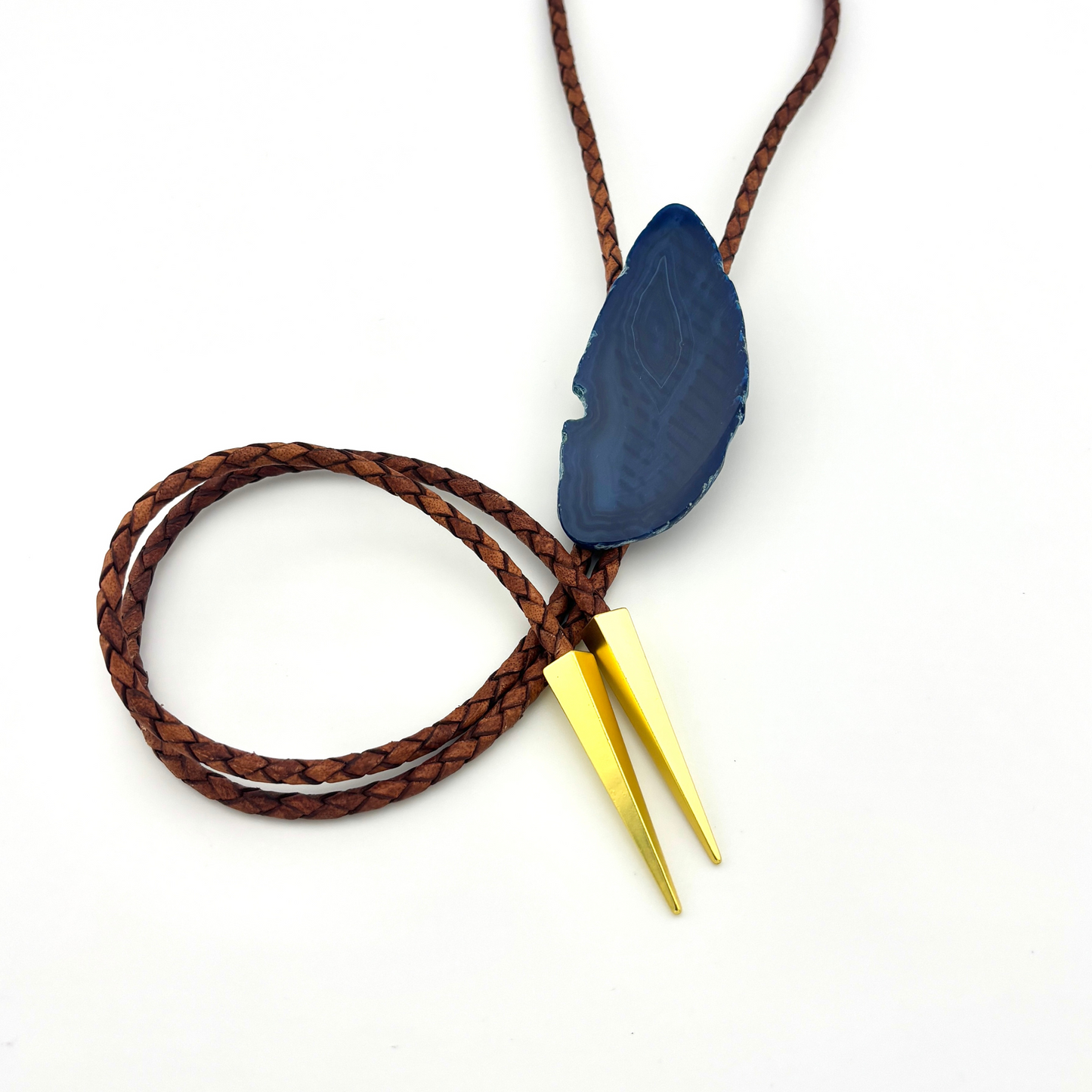 Necklace with a blue pendant and gold accents on a white background