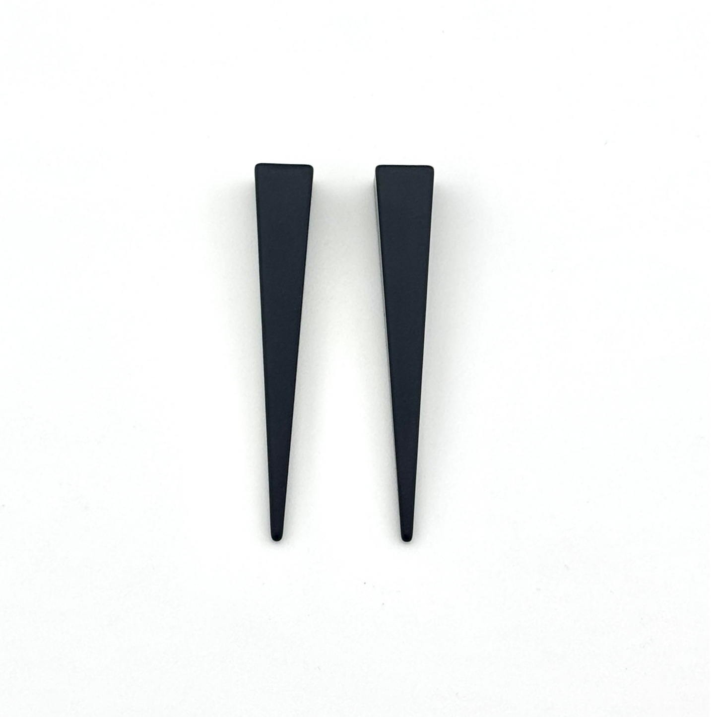 Pair of black triangular earrings on a white background