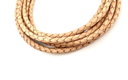 Beige braided leather cord on a white background