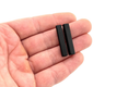 Bar bolo tie tips - two black pieces held in hand, perfect accessory for bolo tie makers.