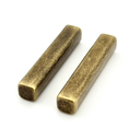 Two antique brass -colored cylindrical objects on a white background